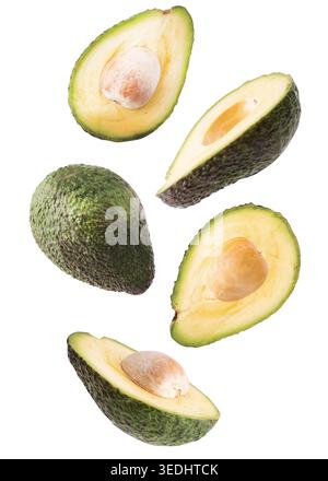 Creative concept with flying avocado fruit. Sliced avocado isolated on white background. Levity fruit floating in the air Stock Photo