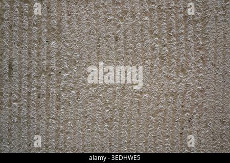 Beige ridged plaster wall texture with vertical grooved pattern in Clermont-Ferrand Stock Photo