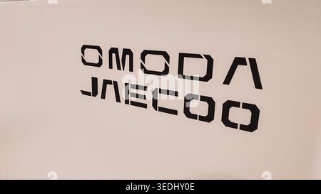 April 24, 2026, Orenburg, Russia: OMODA JAECOO lettering on white wall background for modern minimal interior signage and graphic design use Stock Photo