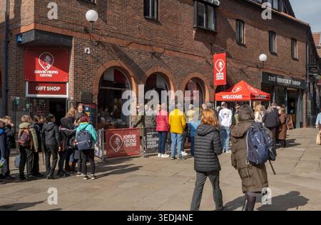 Tourists people queuing outside Jorvik Viking Centre in spring Coppergate York North Yorkshire England UK United Kingdom GB Great Britain Stock Photo