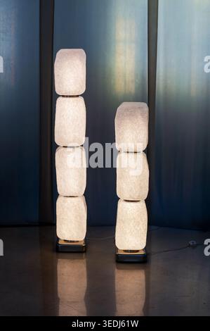 Two modern standing lamps featuring stacked translucent modules creating artistic illumination Stock Photo