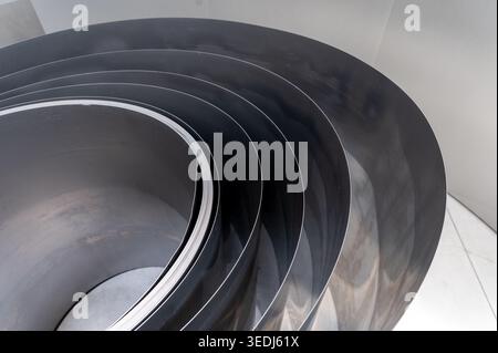 Stainless steel sheets forming abstract curved industrial pattern Stock Photo
