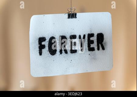Forever word spray painted on textured paper representing commitment and timelessness Stock Photo