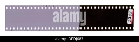 A 35mm analog film strip showing unexposed purple frames and exposed black frames, with a lab number tag , isolated on white background. Stock Photo