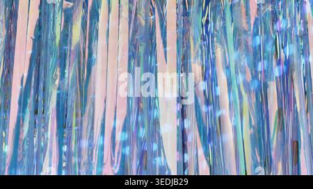 Iridescent tinsel stream creating an abstract shimmering light background Stock Photo