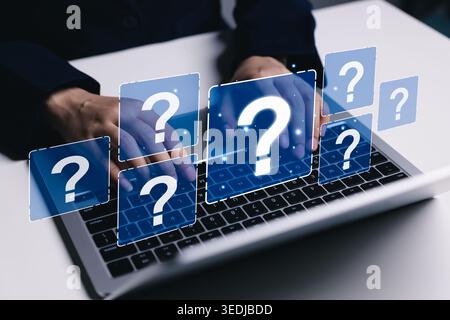 Question FAQ support and online help concept. Professional using laptop with virtual question mark icons, knowledge search, customer inquiry, problem Stock Photo