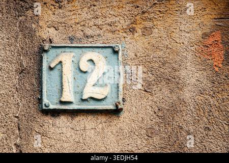 Old,Antique,Cast Iron,Number 12,Weathered,Patina,Rusty,City,Architecture,Facade,Rustic,No People,vintage,retro,iron sign,metal sign,house number,addre Stock Photo