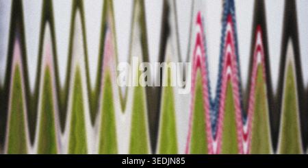 A vibrant abstract background with a repeating zigzag wave pattern in bright green, pink, and blue, set against a light, textured backdrop. Stock Photo