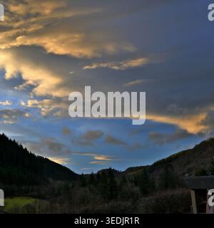 stratocumulus and altocumulus clouds with evening sunlight and blue sky. Stock Photo