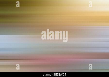 An artistic abstract background with soft horizontal motion blur, blending warm golden yellow tones with cool blue and pinkish highlights. Stock Photo