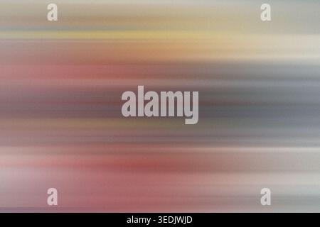 Abstract background featuring soft horizontal motion blur with a blend of warm pink, orange, and cool grey tones, creating a smooth, dreamy atmosphere Stock Photo