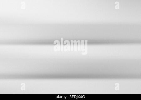 A clean, minimalist abstract background composed of soft, horizontal grey and white gradients, suggesting depth and subtle light transitions. Stock Photo