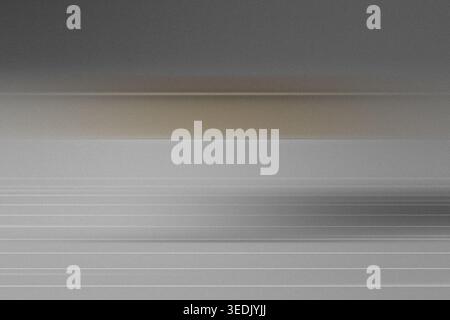 An abstract background featuring soft horizontal motion blur lines with a subtle warm brown accent, creating a calm and sophisticated visual texture. Stock Photo