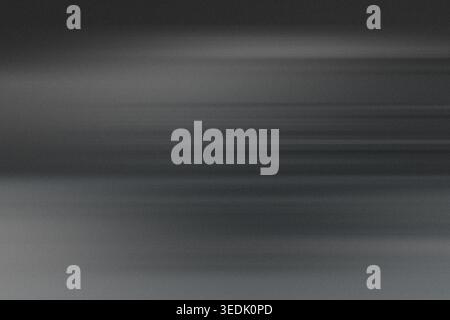 A dark, moody abstract background with horizontal motion blur streaks, creating a sophisticated and atmospheric aesthetic. Stock Photo