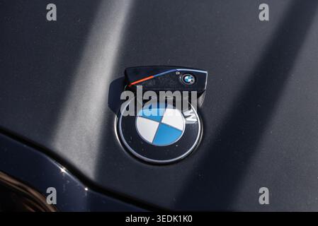 Slovenia, Ljubljana - 8 April 2026: A BMW car key is resting on the logo of a BMW vehicle under sunlight. Stock Photo