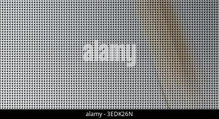 A high-resolution image of a metallic grid surface composed of small circular elements, featuring a soft diagonal light gradient across the pattern. Stock Photo