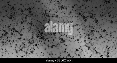 An abstract artistic background featuring a soft grey gradient texture overlaid with various sizes of black ink splatters and spots, creating a grunge Stock Photo