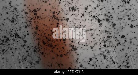 An abstract artistic background featuring scattered black ink droplets and splatters over a soft, hazy red and grey gradient texture. Stock Photo