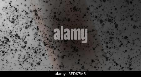 An artistic abstract background featuring scattered black ink splatters and spots over a soft, muted grey and beige gradient texture. Stock Photo