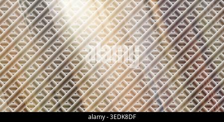 An abstract background featuring a diagonal metallic mesh pattern with warm, golden-brown lighting effects and a soft, glowing gradient finish. Stock Photo