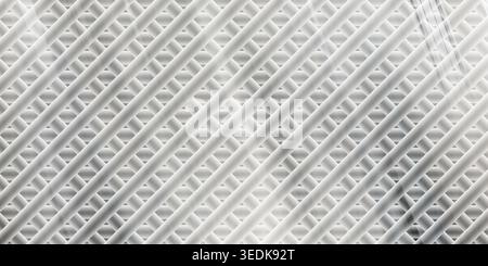 An abstract background featuring a pattern of diagonal, intersecting metallic rods with a brushed steel texture and dramatic light flares. Stock Photo
