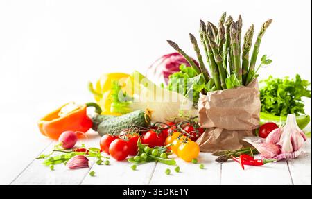 Various types of fresh vegetables and herbs on a  white wooden background. Concept of healthy eating, fresh vegetables. Stock Photo