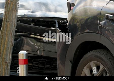 Two cars are badly damaged in a city street, a clear sign of a recent collision. Stock Photo