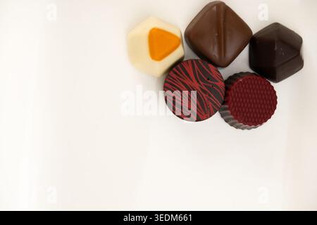 Assorted Gourmet Chocolate Pralines with Artistic Designs on White Background Stock Photo