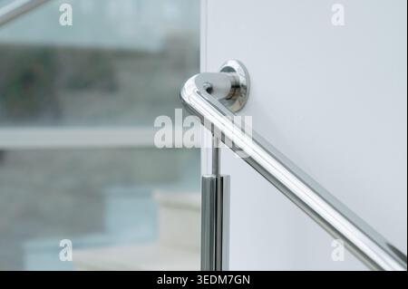 Detailed View Of Stainless Steel Support Bracket Securing Glass Balustrade To Stairs Stock Photo