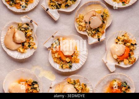 Cooked scallops with sauce on a baking sheet Stock Photo