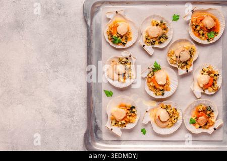 Cooked scallops with sauce on a baking sheet Stock Photo