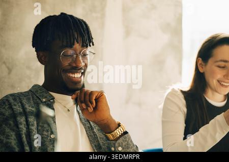 Smiling male and female colleagues working together at modern startup office Stock Photo