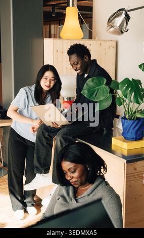 Group of diverse computer programmers working on laptop at office Stock Photo