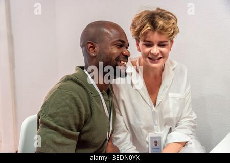 Diverse colleagues smiling and collaborating in an office setting Stock Photo