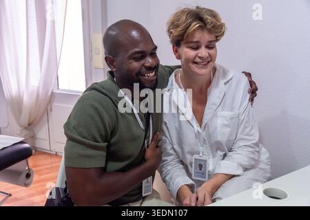Diverse coworkers sharing laughter and positive friendship Stock Photo