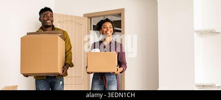 Couple Carrying Moving Boxes in New Home During Daytime Stock Photo