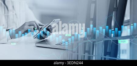 Mexican businesswoman using laptop and cell phone Stock Photo