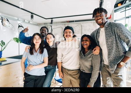 Happy team of diverse coworkers posing for photo at their workspace Stock Photo