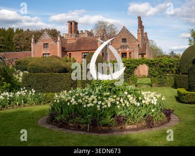 Chenies Manor seen from the topiary garden at Tulip time.. Stock Photo
