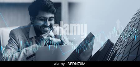 Hindu professional businessman wearing eyeglasses looking at laptop in office Stock Photo