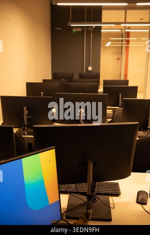 IT Training Center Interior with Desktop Computers in Warm Light, vertical image Stock Photo