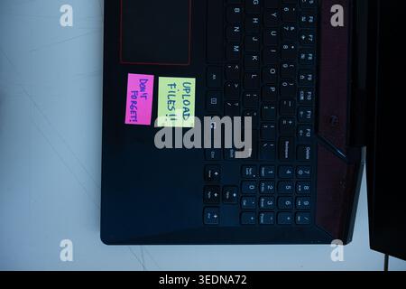 Vertical Concept of Upload Files Reminder Notes on Laptop Stock Photo