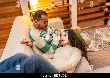 Happy couple relaxing together on sofa at home Stock Photo