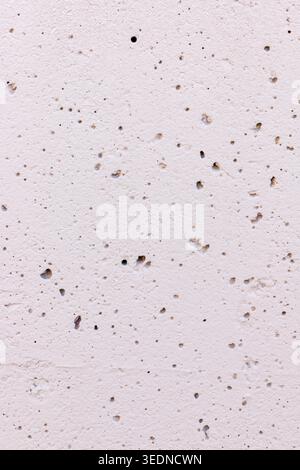 Beige cement surface background detail. Smooth concrete wall texture with pits Stock Photo
