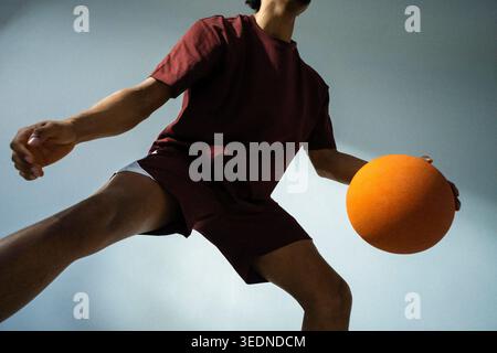 Low angle midsection view of young man showing basketball skills Stock Photo