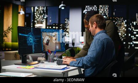 Diverse team of engineers using artificial intelligence to design a floor plan, working together with neural networks and computer aided apartment layout on architectural software. Camera B. Stock Photo