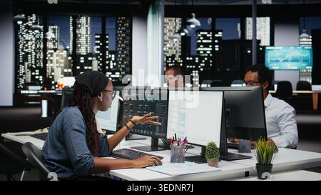 Programmer in Silicon Valley company office struggling with errors while developing apps. Employee frustrated by glitches while debugging applications with machine learning coding Stock Photo