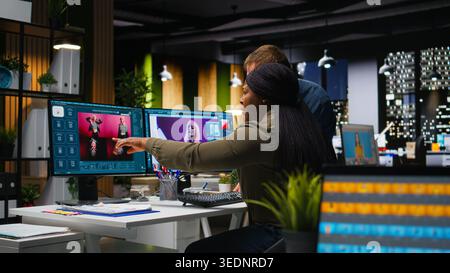 Two photo editors using AI tools and program for retouching and generating content, professional images for creative industry. Diverse photographers editing materials, text to image. Camera A. Stock Photo