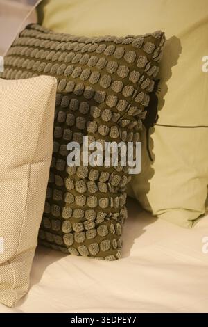 Decorative pillows on a bed in a cozy room Stock Photo