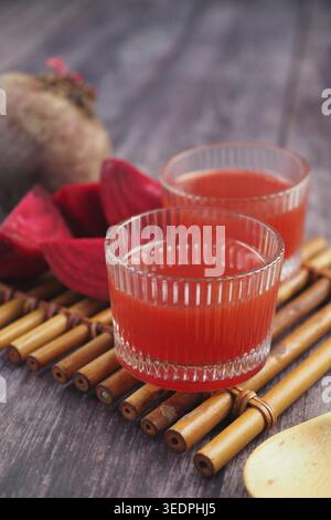 Two clear glasses with beet juice on a bamboo mat Stock Photo